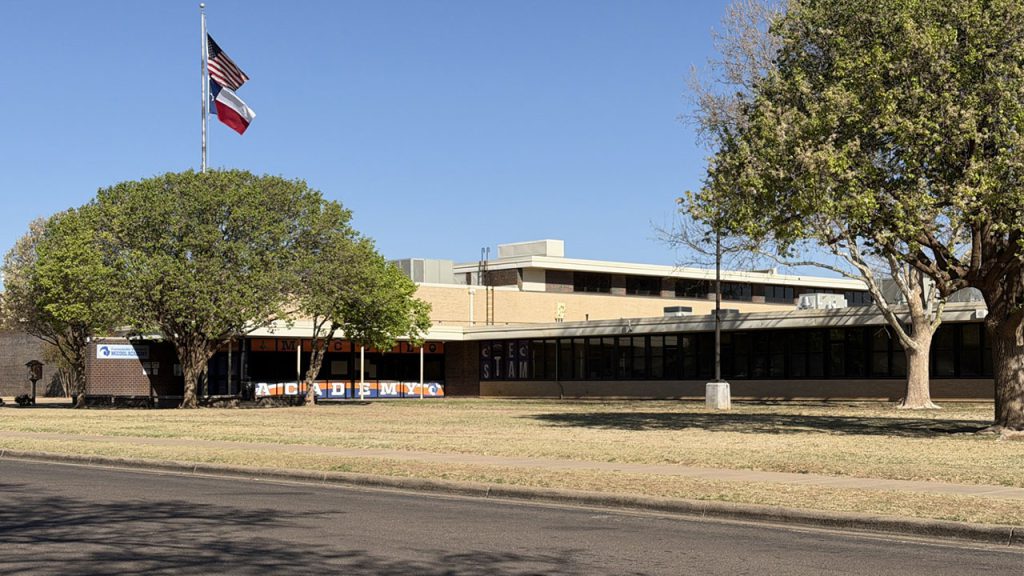 The exterior of McCool Academy in Lubbock, looking deceptively peaceful for a place where the commute involves dodging bumpers.