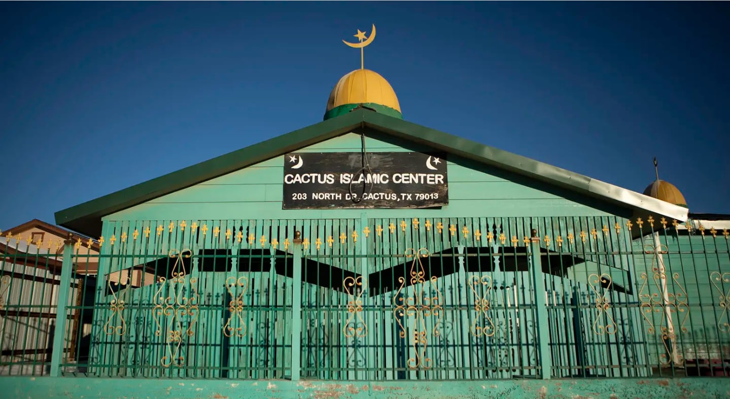The Cactus Islamic Center located at 203 North Dr in Cactus, Texas, featuring a modest green building with a gold dome and crescent moon, which serves as a home for part of the less than 2% of the population currently being targeted by "fear mongering" rhetoric and used as a "political football" by state officials.