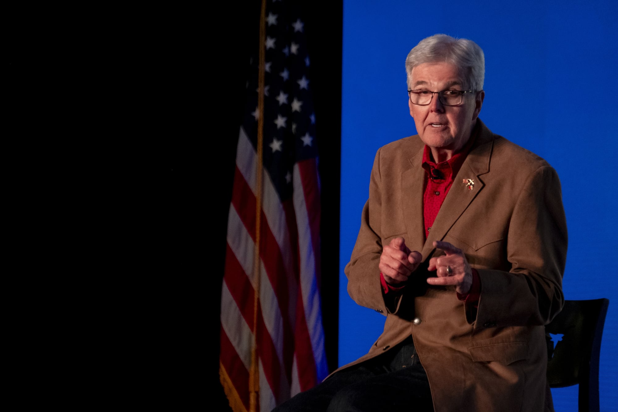 Lt. Gov. Dan Patrick, sporting a tan blazer that screams "I definitely own a ranch I never visit," uses aggressive double finger guns to emphasize exactly how many seats he thinks the GOP is about to lose while speaking at the 2026 TPPF summit.