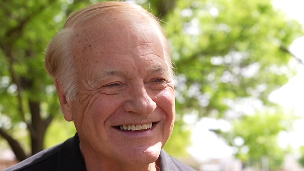 A close-up of Gary Boren grinning like a man who just realized "six months" and "two months" are actually different numbers.