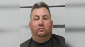 A mugshot of Margarito Sarmiento Espinoza, sporting a neutral expression and some facial stubble, posing in front of the Lubbock County Jail’s height-marker backdrop after his Mackenzie Park Easter celebration went south.