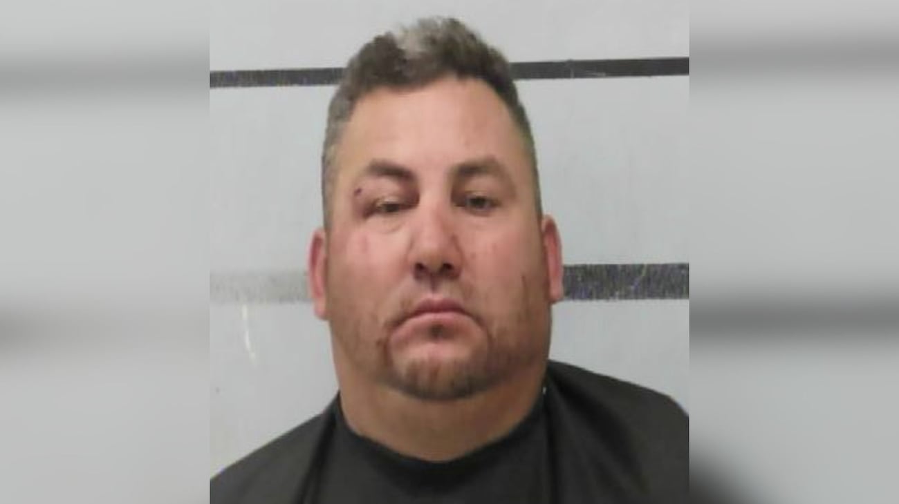 A mugshot of Margarito Sarmiento Espinoza, sporting a neutral expression and some facial stubble, posing in front of the Lubbock County Jail’s height-marker backdrop after his Mackenzie Park Easter celebration went south.