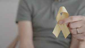 A person holding a yellow awareness ribbon, representing suicide prevention and the high volume of crisis calls in Lubbock.