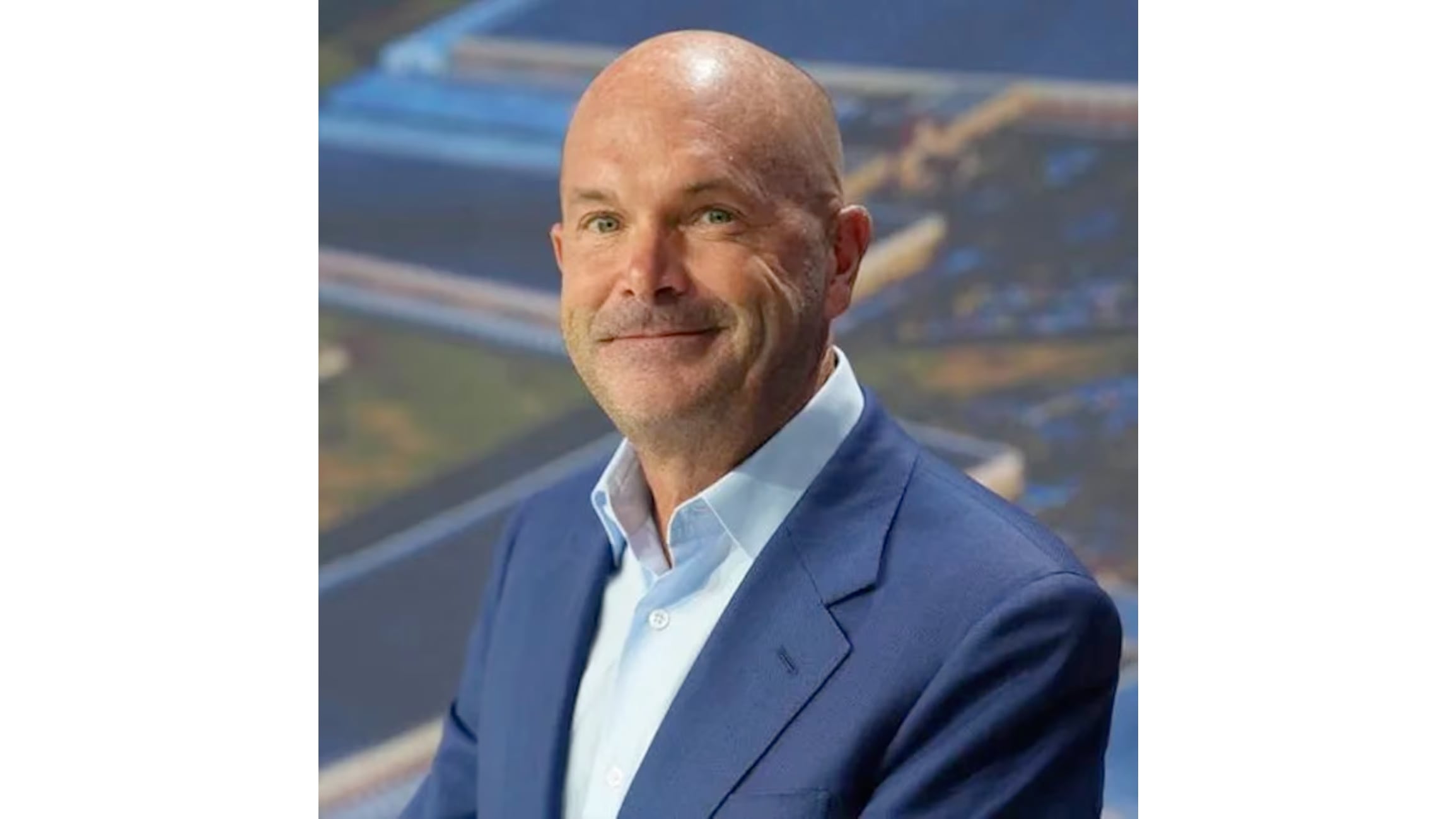 A promotional headshot of a bald Toby Neugebauer in a blue suit, looking smugly into the camera while his multi-billion dollar AI project collapses behind him.