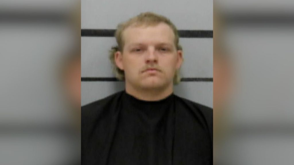 Mugshot of Zachary Peterson, featuring a blonde mullet and a mustache, looking remarkably unbothered for someone who just fumbled the most generous probation deal in Lubbock history.