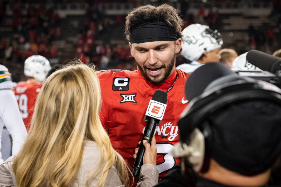 Texas Tech transfer quarterback Brendan Sorsby speaking into an ESPN microphone during a post-game interview while wearing a red jersey.