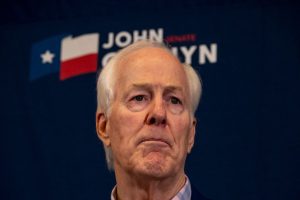 A close-up of a disappointed Senator John Cornyn looking onward at a press conference following his primary runoff defeat.