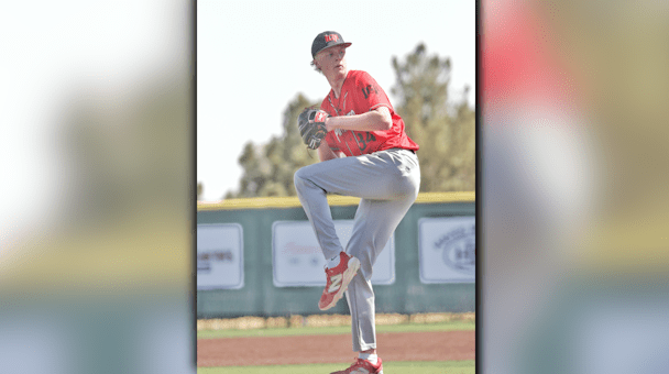 A teenage Lubbock-Cooper baseball pitcher mid-throw on the mound during a game.