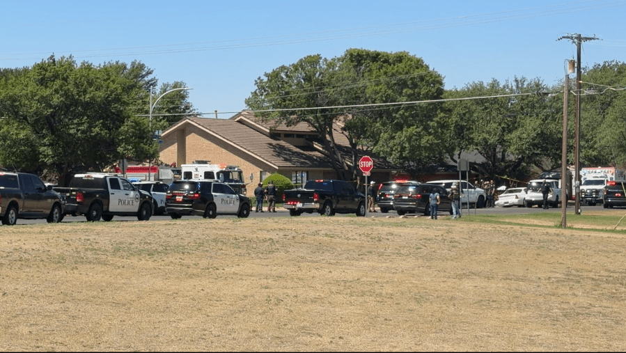 A cluster of police SUVs and emergency vehicles blocking off a residential street in Lubbock following a fatal pursuit.