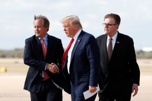 Donald Trump walking alongside Ken Paxton and another official on a tarmac, illustrating the tight alignment of the Texas Republican leadership.