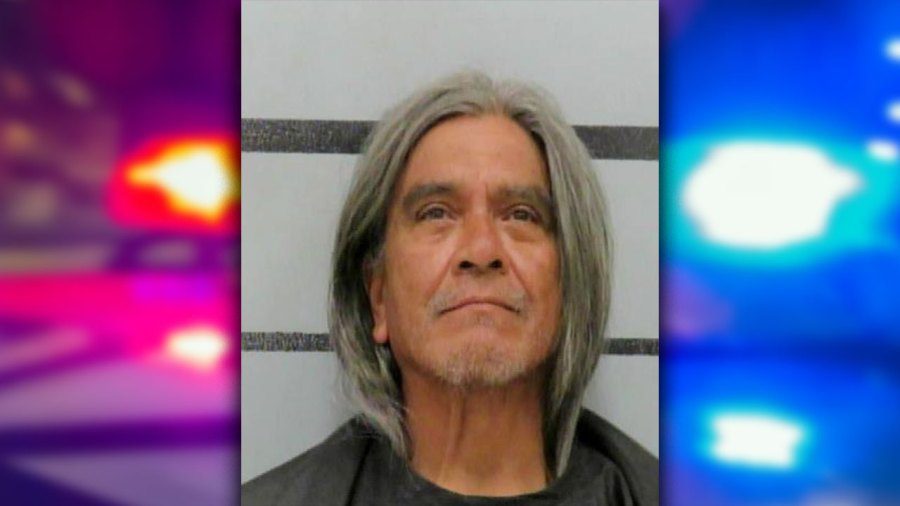 Mugshot of 58-year-old Gregorio Dominguez with long gray hair, flanked by a digital background of blurred red and blue police lights.