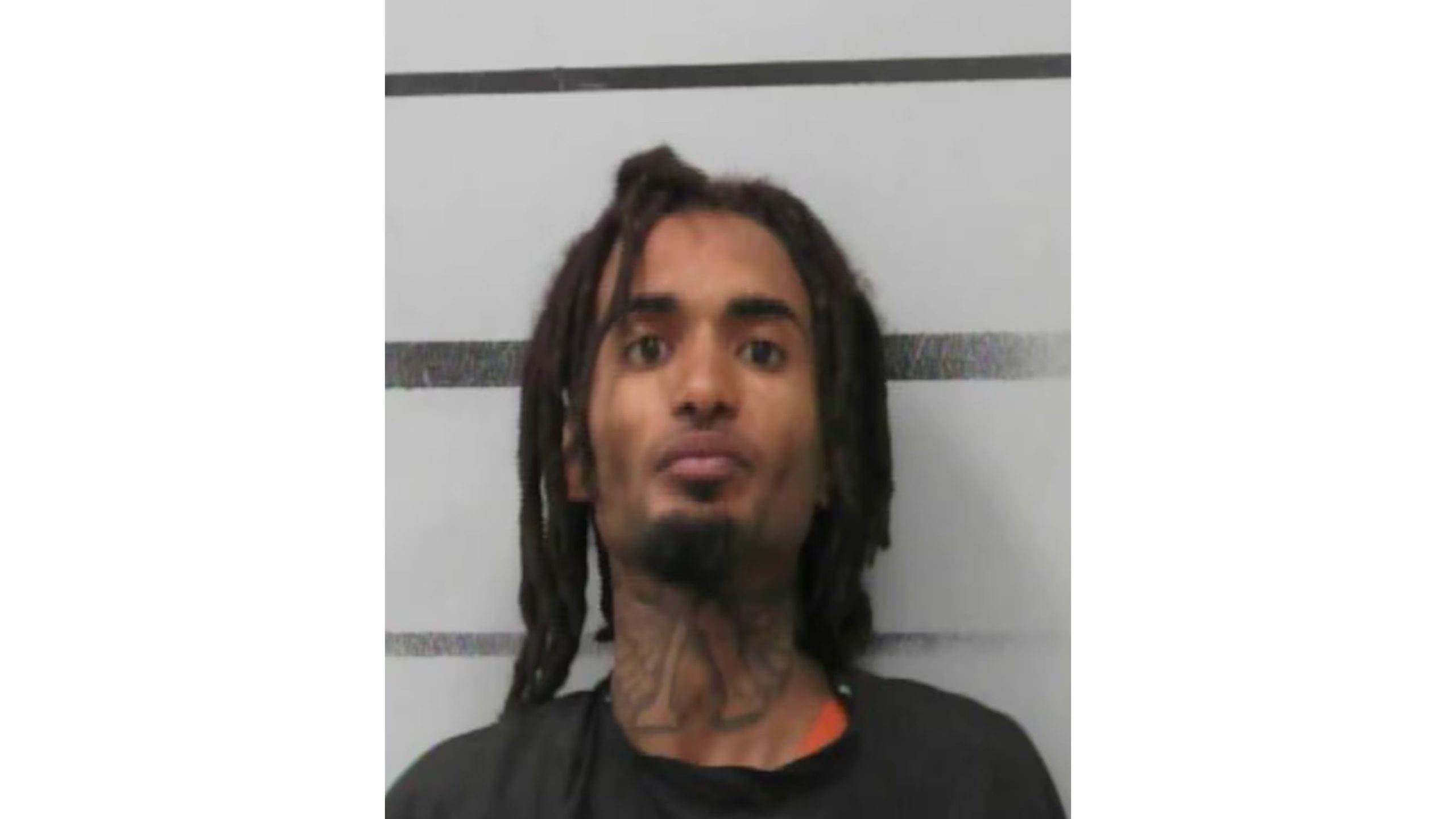 Mugshot of Isaiah Houston, a 26-year-old man with dreadlocks and a neck tattoo, following his arrest for an attempted carjacking in downtown Lubbock.